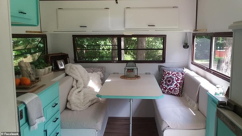 Cozy! The newly renovated RV features white walls with bright teal cabinets and accents