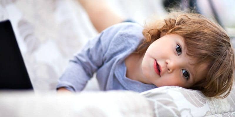 two year old toddler laying on couch