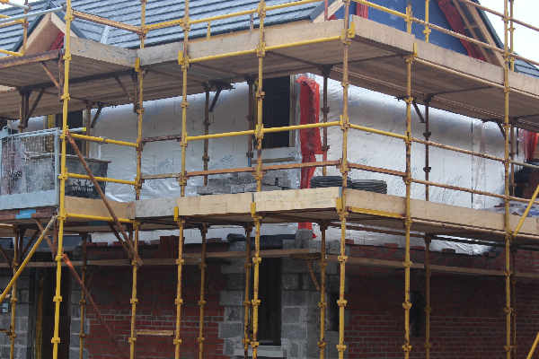 External brick leaf of timber frame wall being built.